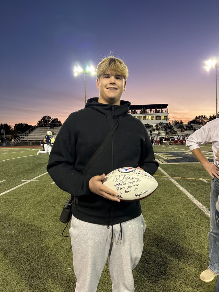 Spencer holding a football.