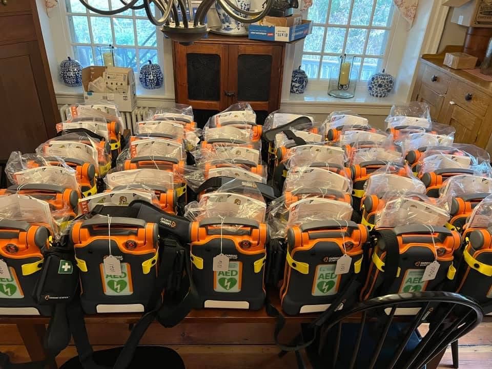 Table lined up with orange AEDs